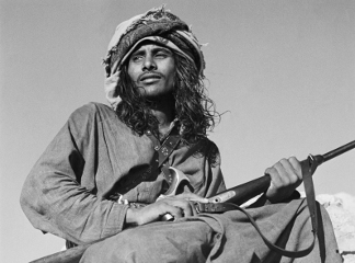 Seated portrait of Salim bin Ghabaisha, one of Wilfred Thesiger's Bedouin companions, in Ras Al Khaimah Emirate, United Arab Emirates, March – April 1950 (b/w photo), Wilfred Patrick Thesiger, (1910-2003) / Pitt Rivers Museum, Oxford, UK