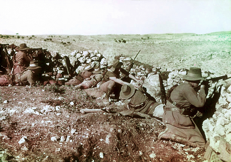 Soldiers of the 2nd Australian Light Horse Regiment behind the front line barricades at Nalin during the war against the Ottoman Empire, Palestine, 17th January, 1918 (colour Paget plate) by Frank Hurley, (1885-1962)